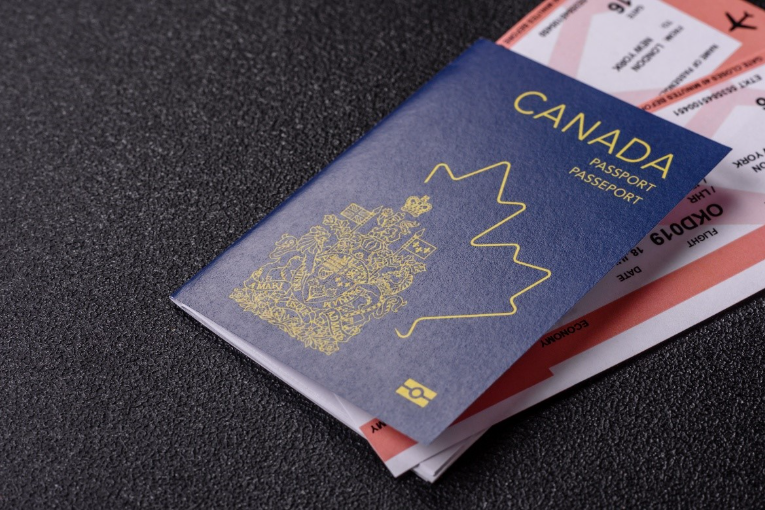 A Canadian passport with tickets in it