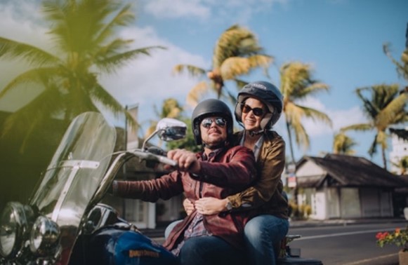 man and women enjoying a motorcycle ride